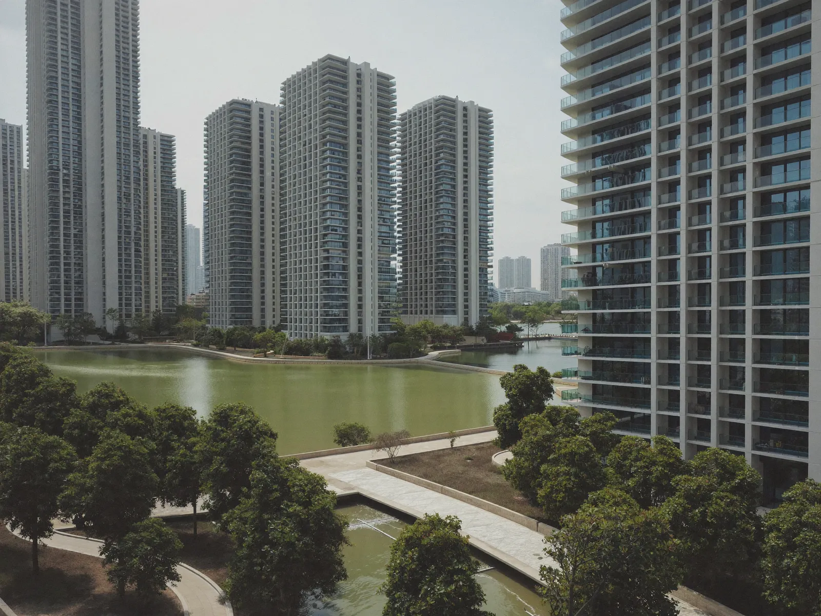 Residential glass towers around a lake in Jumeirah Lake Towers, Dubai